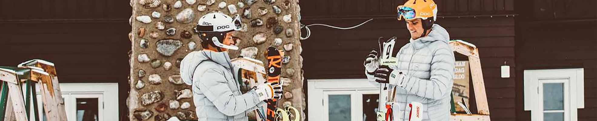 two skiers standing in front of club house