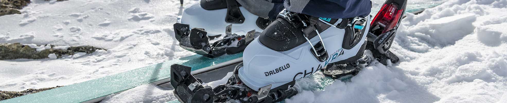 paid of ski boots clipping into ski bindings