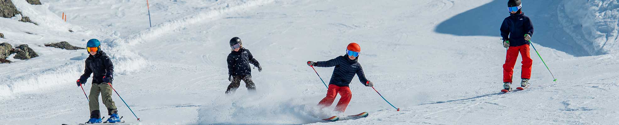 kids skiing down the slope