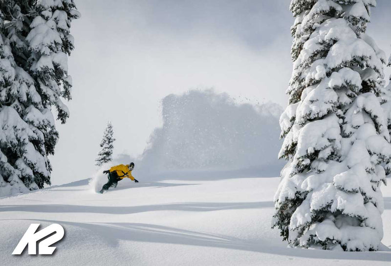man snowboarding in deep powder