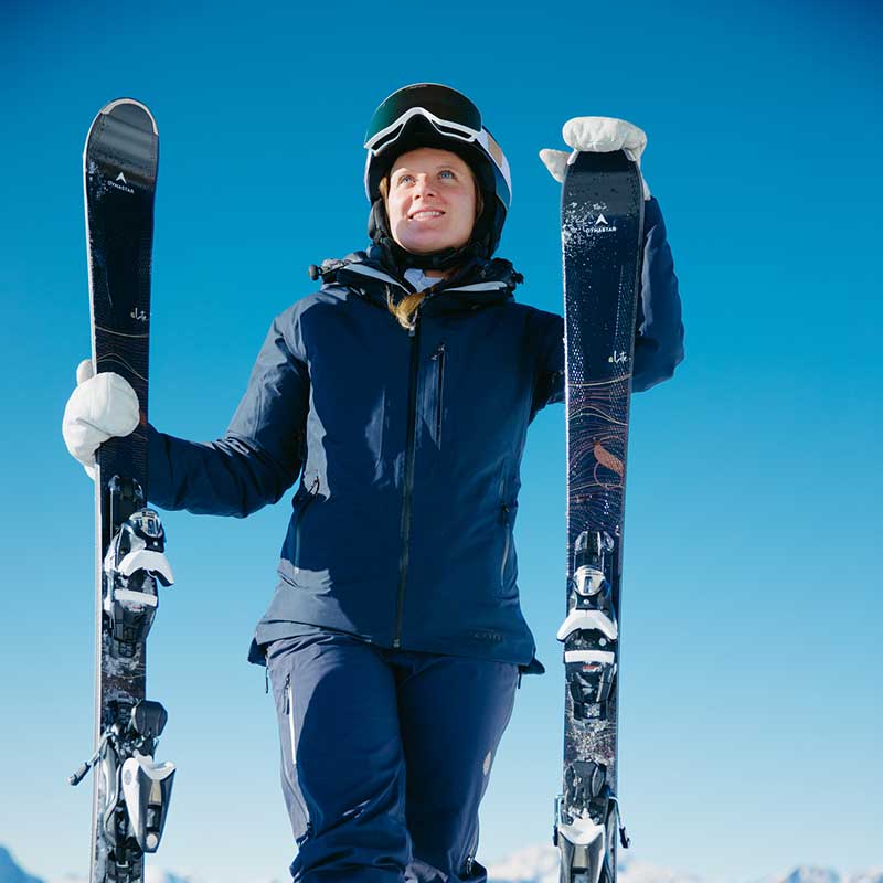 woman standing with skis