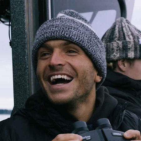 Man smiling wearing a hat