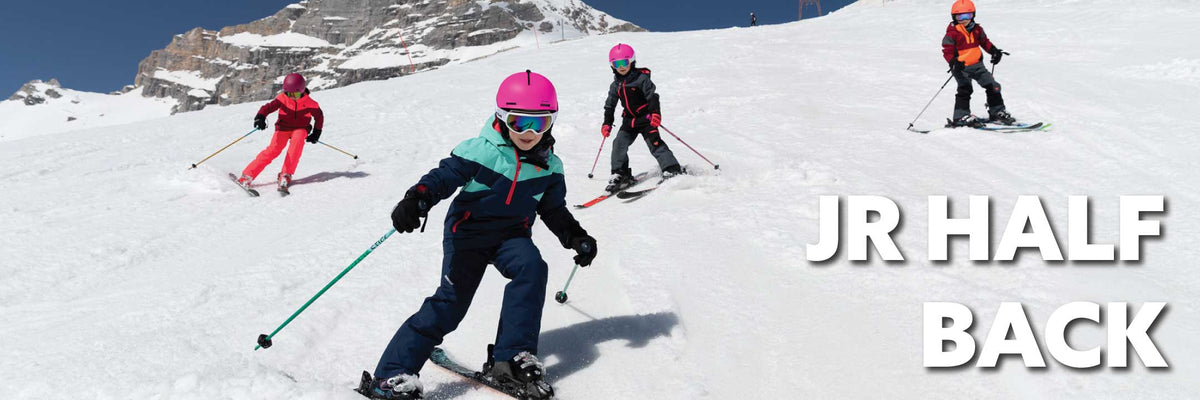 4 young skiers skiing down the hill
