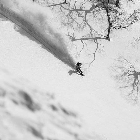 snowboarder snowboarding down hill