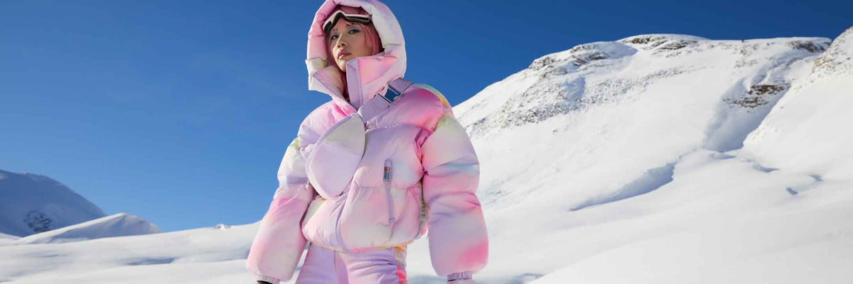 woman standing in front of a snow covered mountain